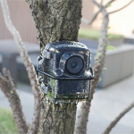 Brinno TLC2020 time lapse camera placed in green leaves for outdoor use